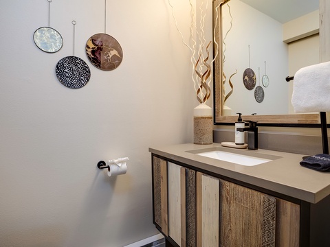 Step into your stylishly appointed bathroom, where natural wood accents and modern fixtures create a warm, spa-like retreat. Fresh towels await as you prepare for your day.