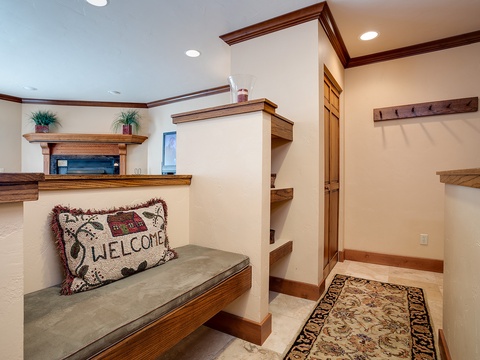Step into your welcoming entryway, where warm wood tones and thoughtful built-ins create a cozy spot to drop your bags, hang your coat, and truly settle in.