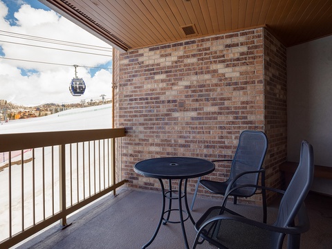 Your private balcony overlooks ski slopes and gondolas, offering mountain views. Sip morning coffee at the bistro table while watching skiers glide down the runs.