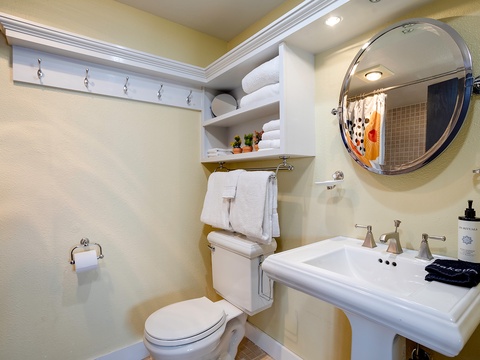 Your private bathroom features crisp white fixtures, plush towels, and thoughtful amenities—everything you need to refresh after exploring or unwind before a restful night's sleep.