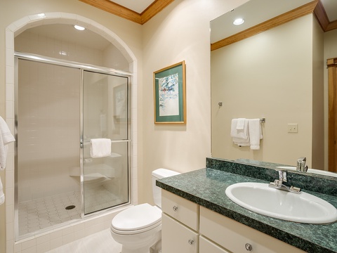Your private bathroom offers a spacious walk-in shower, elegant granite countertops, and all the amenities you need to refresh and recharge after your day.