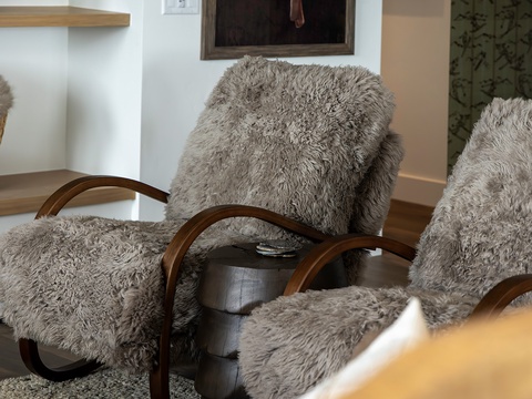 Sink into plush faux-fur comfort in your cozy living space, where modern style meets inviting warmth and you can truly unwind after a day of adventure.