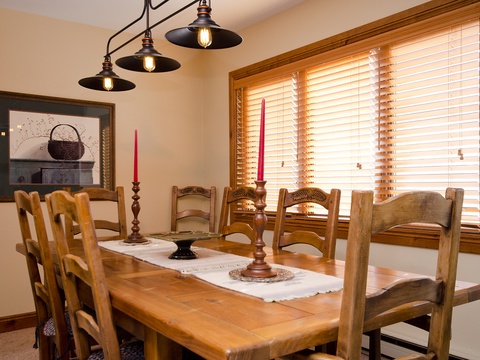 Gather around this inviting dining table, where warm wood tones and soft natural light create the perfect setting for your morning coffee or evening meals with loved ones.