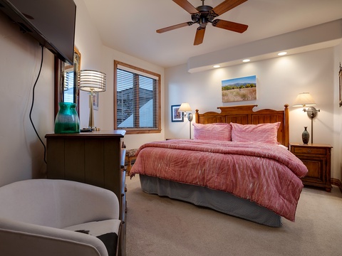 Settle into your cozy bedroom, where soft linens, warm lighting, and a gentle ceiling fan create the perfect retreat after your day of adventure.