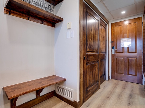 Your private entrance welcomes you with warm wood tones and thoughtful details. Store your gear on the rustic bench, hang coats on sturdy hooks, and enjoy the cozy, well-organized entryway that makes settling in effortless.