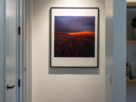 A softly lit hallway welcomes you with warm wood floors and clean, modern lines that connect your private spaces throughout the home.