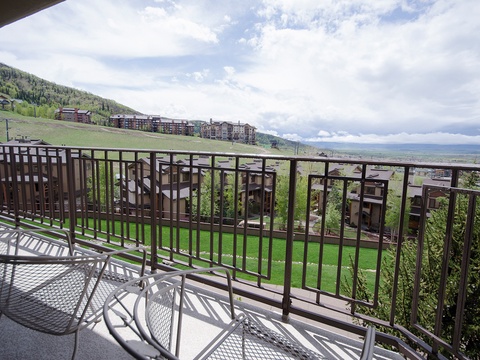 A mountain resort setting with ski slopes, lodges, and valley views visible from the surrounding area during summer season.