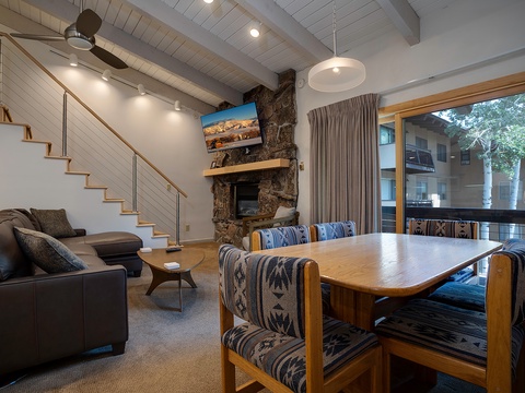 Relax in your open-concept living space with vaulted ceilings, a cozy stone fireplace, and easy access to your private balcony—perfect for unwinding after a day of adventure.
