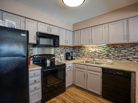 Your fully equipped kitchen features modern appliances, elegant cabinetry, and stylish tile backsplash—everything you need to whip up your favorite meals with ease.