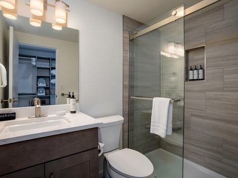 Step into your beautifully designed bathroom, where modern elegance meets everyday comfort. Fresh towels, a spacious glass shower, and warm lighting create the perfect retreat after a day of exploring.