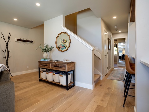 Warm hardwood floors and thoughtfully curated décor create a welcoming entryway where you'll instantly feel at home, with easy access to cozy sleeping quarters and inviting common spaces.