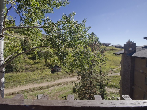 Mountain resort setting framed by aspens, slopes, and pathways—perfect for year-round getaways.