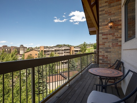 This private balcony offers comfortable seating where you can sip your morning coffee while taking in the surrounding hillside views and fresh mountain air.