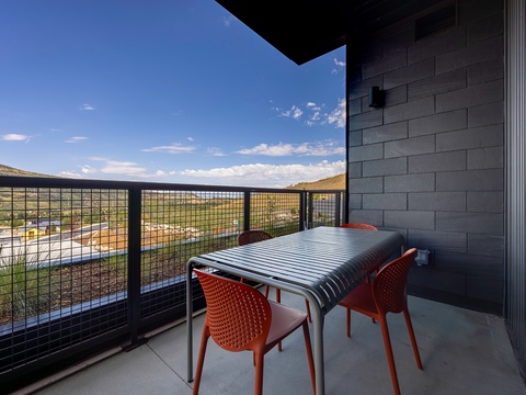 Step outside to your private balcony and soak in stunning desert and mountain views. The modern seating area invites you to enjoy morning coffee or evening sunsets in style.
