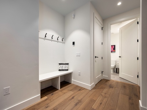 Drop your bags and settle in—wall hooks, built-in bench seating, and a nearby half bath make your arrival effortless and welcoming.