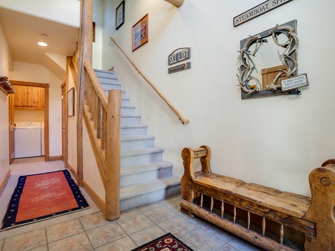 Your mountain getaway begins here, where charming nautical touches and rustic wooden beams welcome you through a warm, inviting entrance with stairway access to all your home's levels.