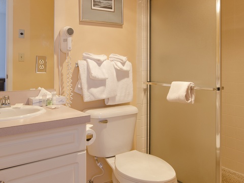 Step into your freshly prepared bathroom with soft towels waiting, a walk-in shower ready for your refresh, and thoughtful amenities like a hairdryer to start your day comfortably.