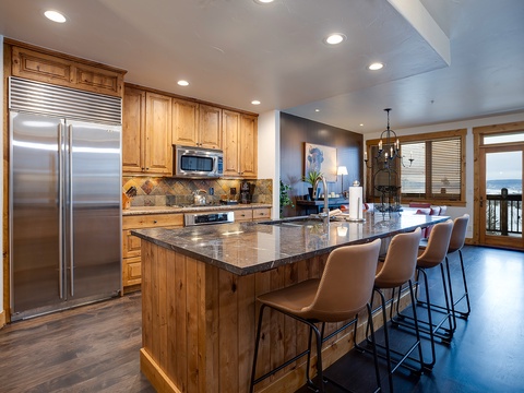 Picture yourself preparing meals in this spacious gourmet kitchen, with gleaming granite counters and stainless appliances. Gather around the island with friends and family, or step onto the balcony to savor stunning ocean views.