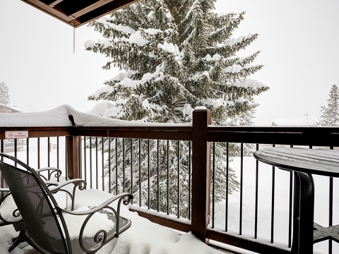 Step onto your private balcony and savor the crisp mountain air as snow blankets the towering evergreens. Your cozy retreat awaits, surrounded by winter's serene beauty.