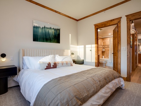 Sink into the plush bedding beneath warm wood accents and wake to natural light streaming in. Your private ensuite awaits just steps away.