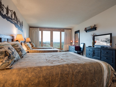 Wake up to stunning lake views from your cozy bedroom, with plush beds and mountain-inspired decor inviting you to relax and recharge in style.