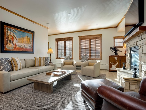 Unwind in your spacious living room, where a cozy stone fireplace and plush seating invite you to relax after a day of adventure.