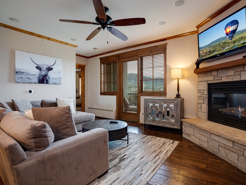 Sink into plush sofas in your cozy living room, warmed by the crackling fireplace and natural mountain light streaming through large windows.