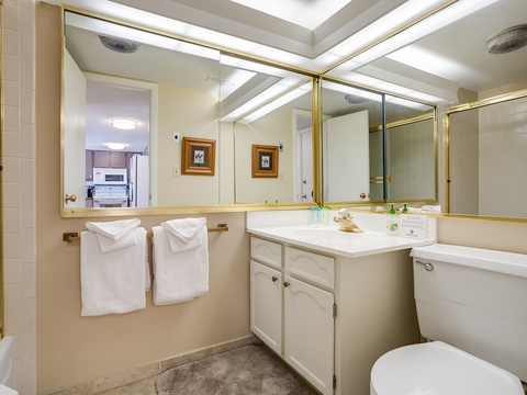 You'll find everything you need in this bright, well-appointed bathroom, complete with fresh linens, a spacious vanity, and thoughtful gold accents that add a touch of elegance.