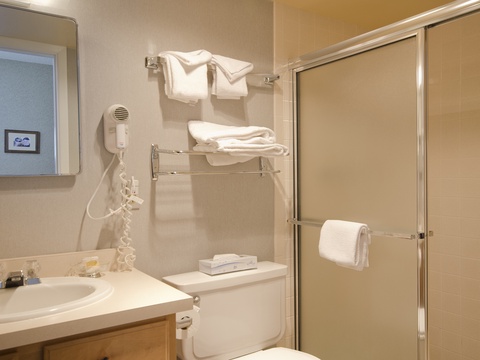Your private bathroom features a spacious shower, fresh towels, and a convenient hair dryer—everything you need to feel refreshed and ready for your day.