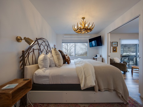 Sink into crisp linens and watch the winter landscape unfold through your window. The unique antler chandelier and natural wood accents bring rustic charm to your peaceful mountain retreat.