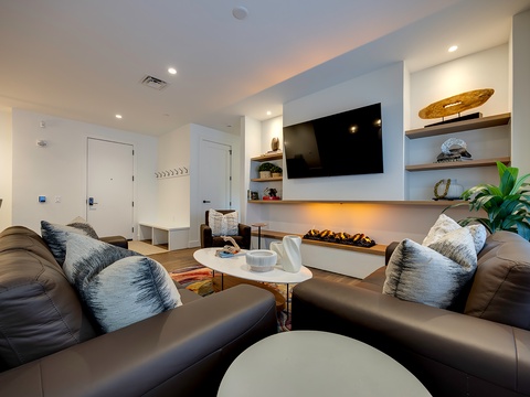 Sink into plush seating and unwind by the sleek fireplace. This modern living space welcomes you with coastal-inspired décor, warm ambient lighting, and all the comforts you need to relax after a day of exploring.