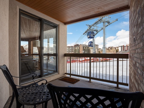 A covered balcony with seating and ski resort gondola views provides direct mountain access and urban convenience.