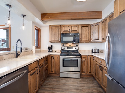Your fully equipped kitchen invites effortless meal prep with modern stainless appliances, warm wood cabinetry, and ample counter space. Gather, cook, and create memories in this welcoming heart of your home.