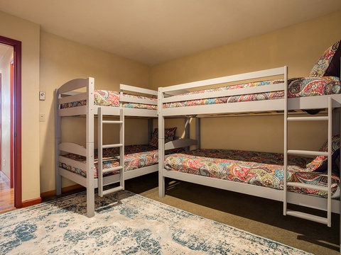 Four cozy bunk beds dressed in cheerful paisley linens await your group, perfect for families or friends traveling together in comfort.