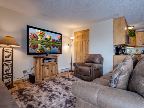 Unwind in your cozy living space, complete with a large flatscreen TV, plush leather seating, and rustic mountain charm that makes you feel right at home.