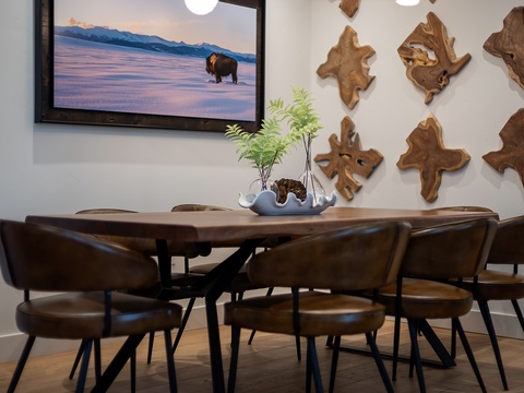 Gather around this handcrafted live-edge table for meals and memories, surrounded by unique wood art that adds rustic mountain charm to your dining experience.