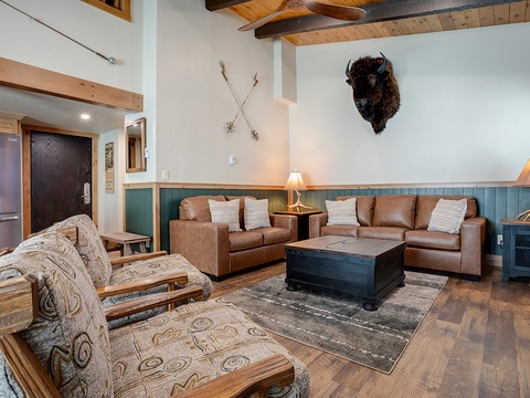 Unwind in your inviting living room where rustic charm meets comfort—perfect for gathering after a day of mountain adventures.