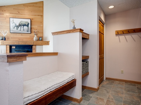 Your private entryway welcomes you with warm wood tones, built-in storage, and a cozy bench where you can settle in after mountain adventures.