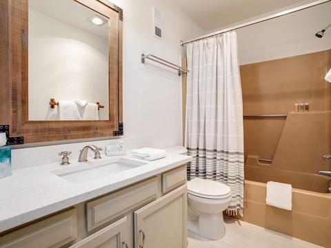 Freshen up in your private bathroom with a spacious vanity, tub-shower combo, and all the essentials for a comfortable stay.