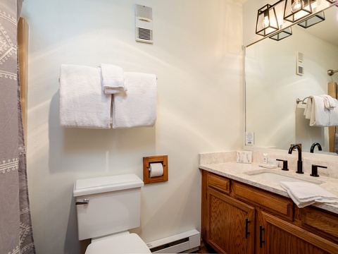 Step into your private bathroom with plush towels, dual vanities, and warm wood accents. Everything you need to refresh after a day of adventure.