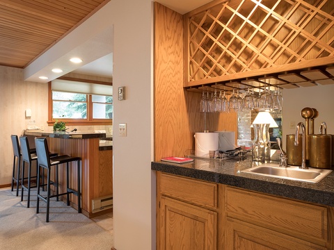 Your private bar area features a stylish lattice wine rack, gleaming countertops, and everything you need to mix drinks and entertain in comfort.
