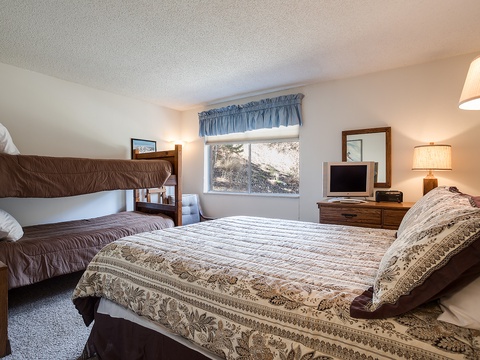 Your family bedroom offers cozy sleeping arrangements with both a comfortable queen bed and sturdy bunk beds, perfect for kids or extra guests.