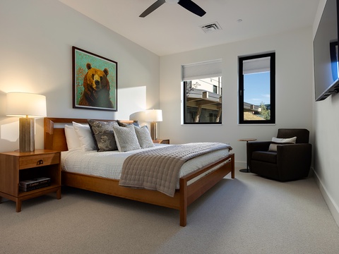 Relax in your serene bedroom with warm wood tones, plush bedding, and bright windows that bring natural light into this peaceful retreat.