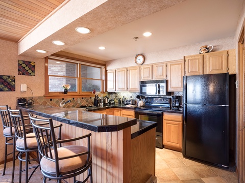 Your fully equipped kitchen awaits with granite countertops, modern appliances, and a convenient breakfast bar where you can sip morning coffee while planning the day's adventures.