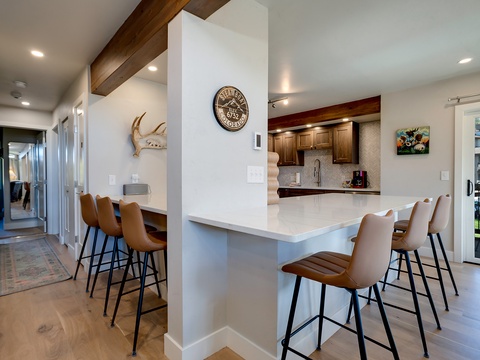 Gather around this spacious kitchen island with comfortable seating for six, perfect for your morning coffee or evening meals together.