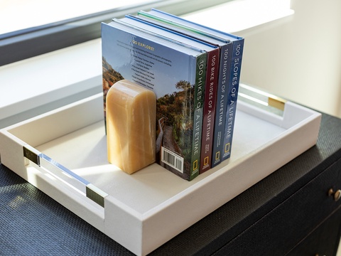Settle in with a curated stack of travel guides waiting on your nightstand—perfect inspiration for planning your next adventure.