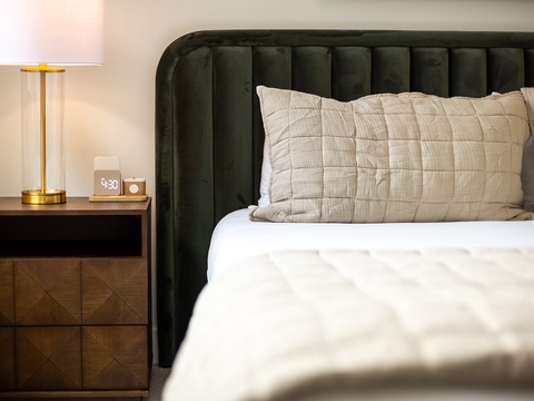 Sink into the plush comfort of your luxurious quilted bedding and stylish tufted headboard, with soft ambient lighting to set the perfect mood for relaxation.