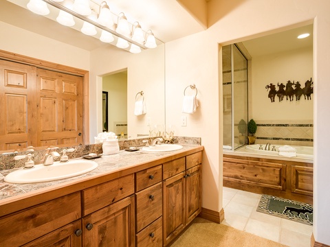Your private bathroom features granite countertops, warm wood cabinetry, and a spa-like soaking tub, creating the perfect retreat to unwind after your adventures.