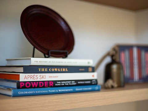 Settle in with a stack of engaging reads placed just for you, featuring local culture, outdoor adventures, and mountain stories perfect for unwinding after a day exploring.