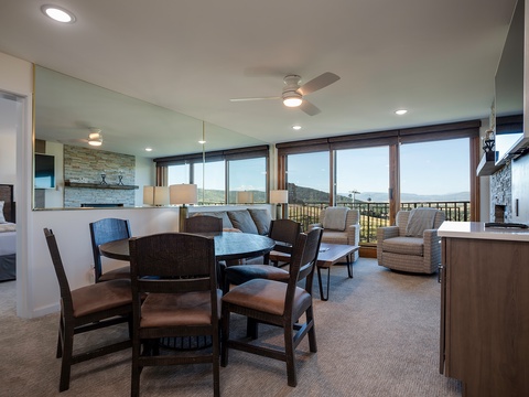 Floor-to-ceiling windows frame sweeping mountain vistas in this open-concept living space, where your dining and lounge areas flow seamlessly together, inviting relaxation and connection with nature's grandeur outside.